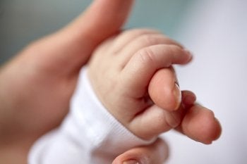 A Person Holding A Baby's Hand In Riverside, CA