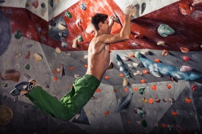 A Man Doing Indoor Rock Climbing In Riverside, CA
