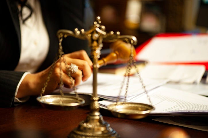 A woman with the scale of justice symbolizing a Government Liability Attorney in Riverside, CA