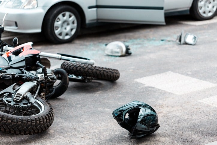 Helmet on the ground depicting a collision for a motorcycle accident attorney in Riverside, CA