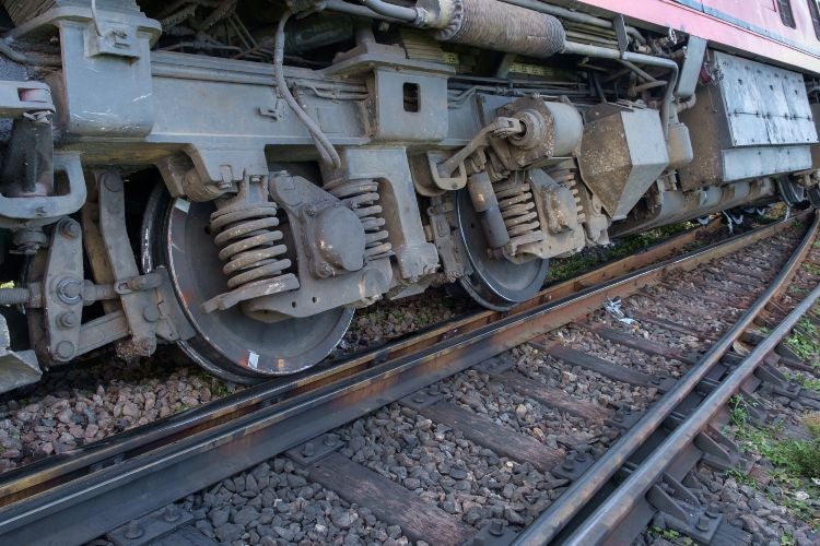 Close-up view of a train's wheels on tracks in Riverside, California.