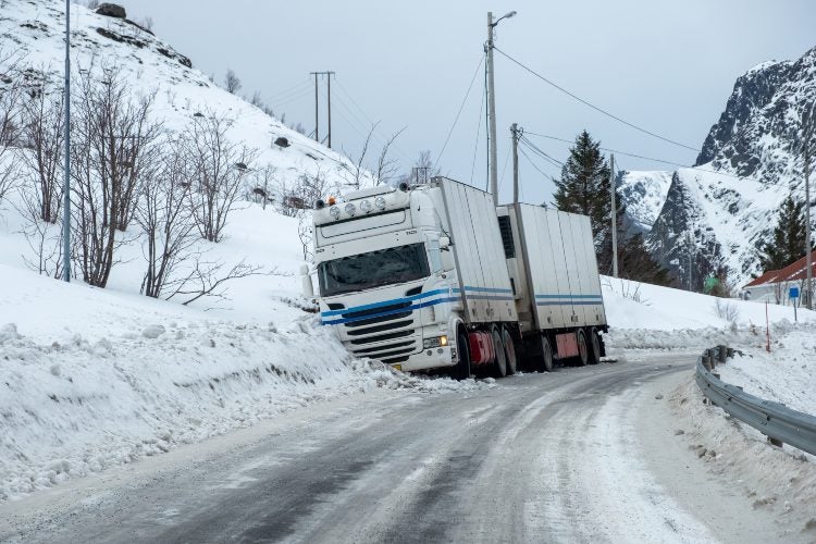 A truck stuck on the side of a snowy road in Riverside, CA